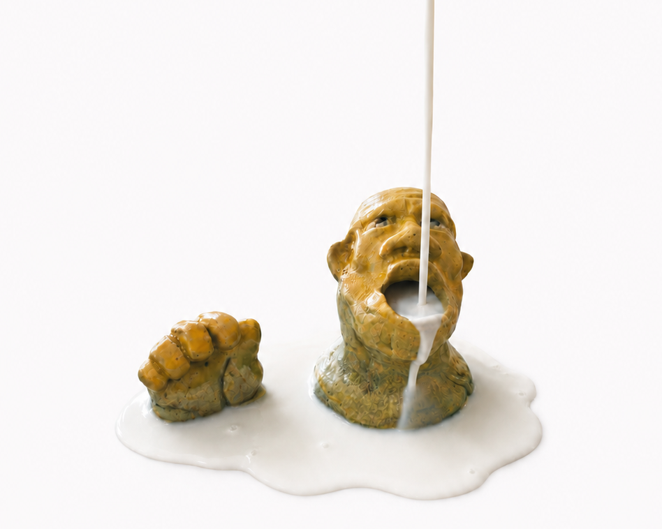 Ceramic sculpture of a face with an incense stick emerging from its mouth on a white background